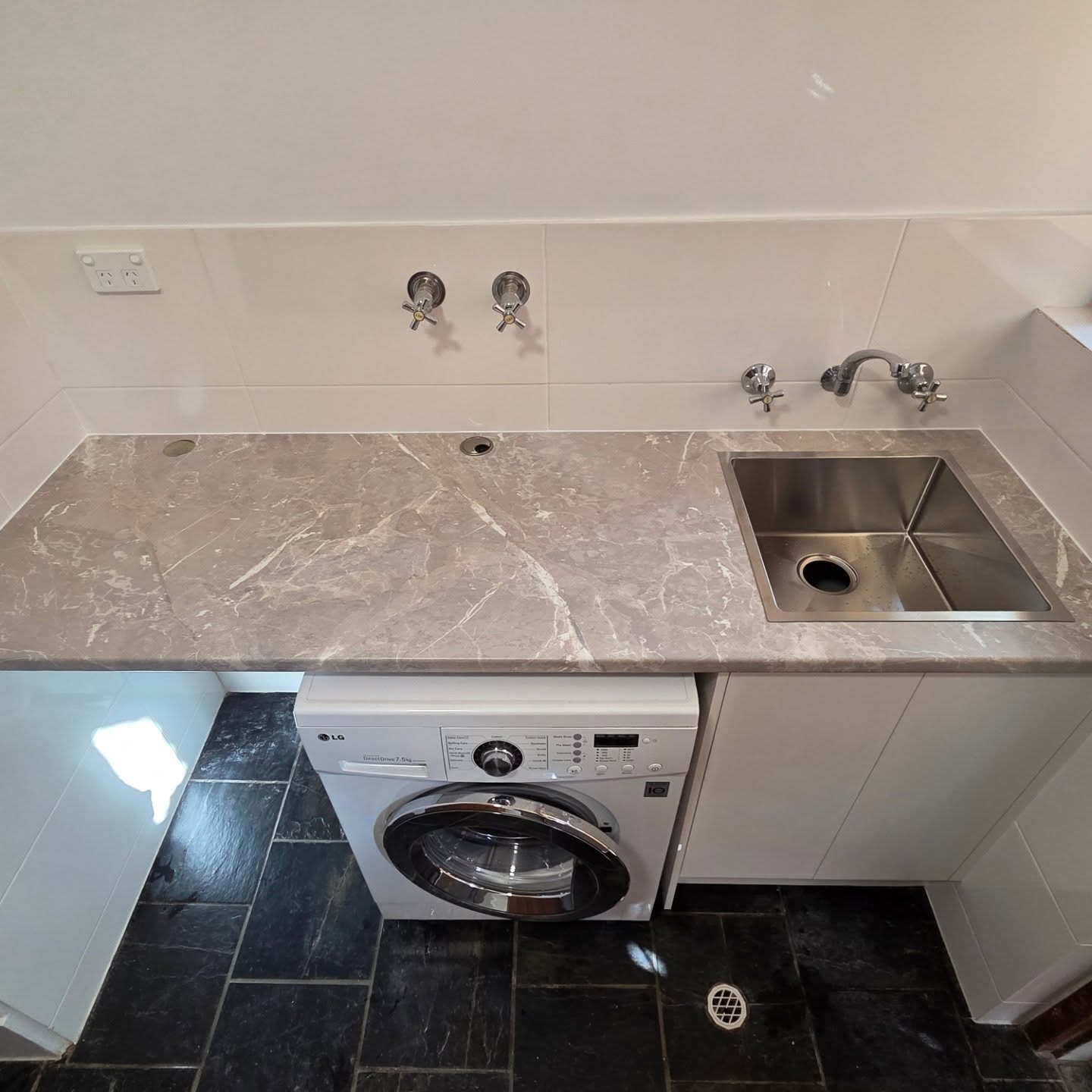 Modern bathroom with stone countertop and stainless steel sink