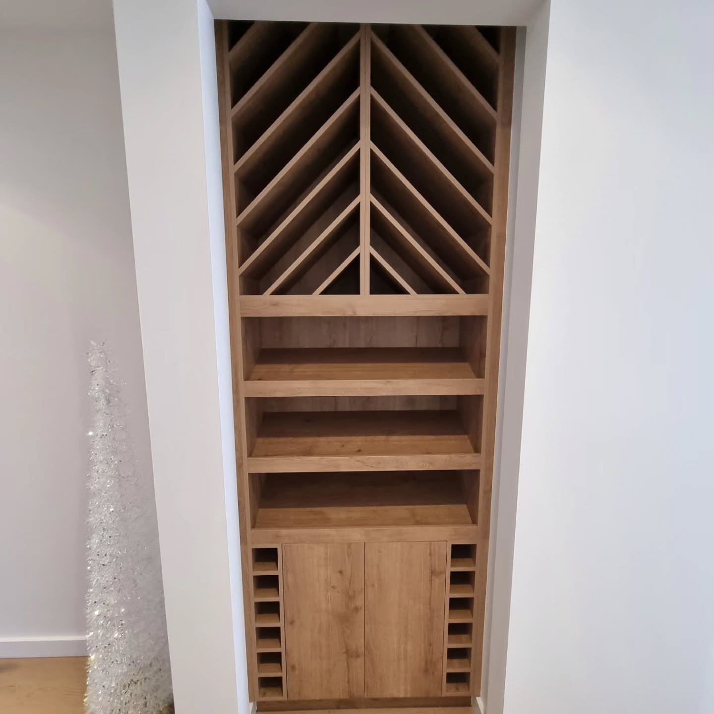 Timber chevron pattern wine rack with custom wooden shelving